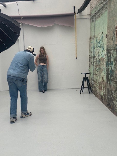 Shooting en studio : un photographe et son modèle devant un fond clair